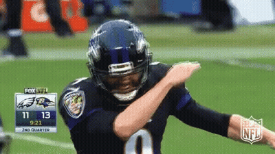 A Football Player Is Doing A Dab On The Field GIF