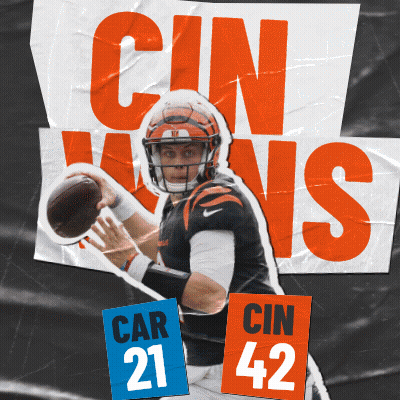 A Football Player Is Holding A Ball In Front Of A Sign That Says Cin Wins GIF
