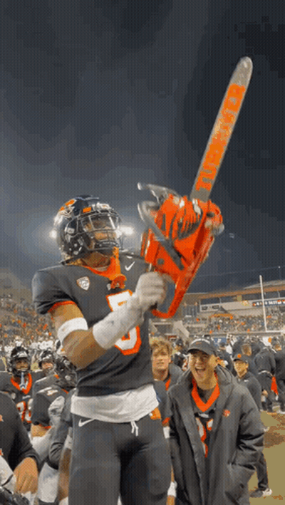 A Football Player Is Holding A Chainsaw That Says Thunder On It GIF
