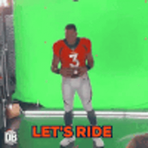 A Football Player Is Holding A Football In Front Of A Green Screen . GIF