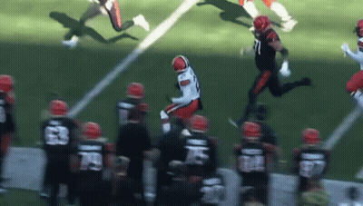 A Football Player Is Jumping In The Air During A Game While Wearing A Number 71 Jersey GIF