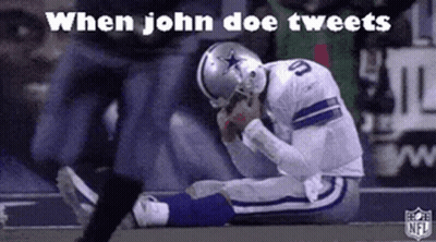 A Football Player Is Kneeling Down On The Field With His Head Down . GIF