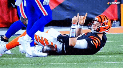 A Football Player Is Laying On The Field And Giving A Thumbs Up Sign GIF