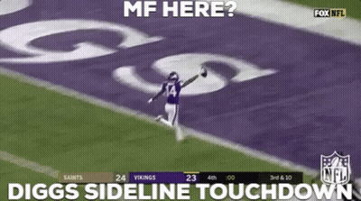 A Football Player Is Running On The Field While Holding A Ball . GIF