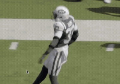 A Football Player Is Running On The Field With His Arms In The Air . GIF