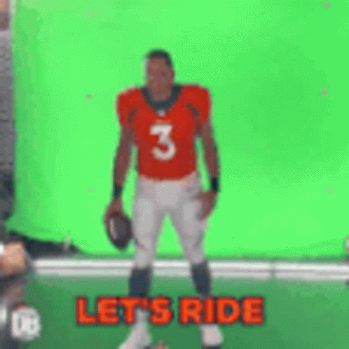 A Football Player Is Standing In Front Of A Green Screen Holding A Football . GIF