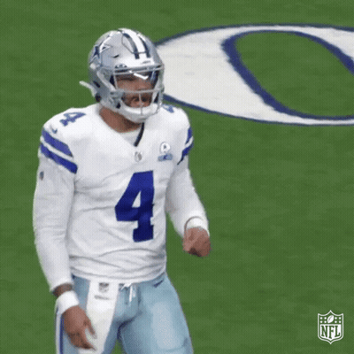 A Football Player Is Standing On A Field Wearing A Helmet And A Number 4 Jersey . GIF
