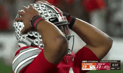 A Football Player Is Wearing A Helmet That Says Buckeyes On It GIF