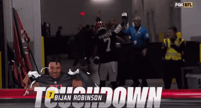 A Football Player Named Brian Robinson Is Being Congratulated GIF