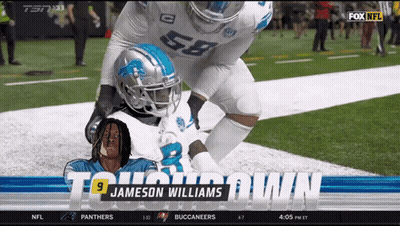 A Football Player Named Jameson Williams Is Laying On The Ground GIF