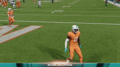A Football Player Named Jaylen Waddle Is Standing On The Field GIF