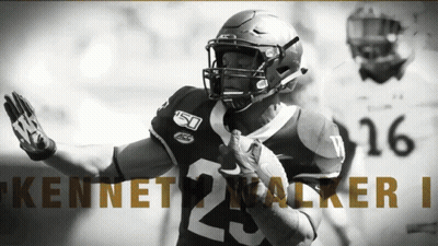 A Football Player Named Kennet Walker Is Running With The Ball GIF