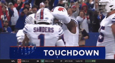 A Football Player Named Sanders Is Celebrating A Touchdown With His Teammates GIF