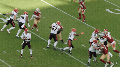 A Football Player Running On A Field With A Netflix Logo GIF