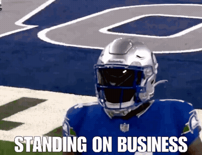 A Football Player Standing On A Field With The Words Standing On Business Written Below Him GIF