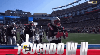 A Football Player Stands On The Field With The Words Touchdown N GIF