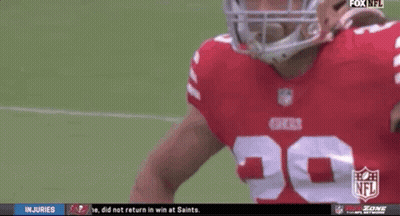 A Football Player Wearing A 49Ers Jersey Stands On The Field GIF