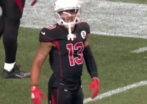 A Football Player Wearing A Black Jersey With The Number 13 On It GIF