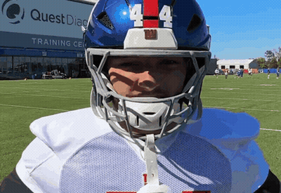 A Football Player Wearing A Blue Helmet With The Number 4 On It GIF