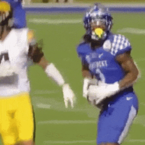 A Football Player Wearing A Blue Jersey That Says Kentucky GIF