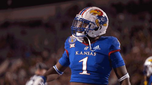 A Football Player Wearing A Blue Jersey With Kansas On It GIF