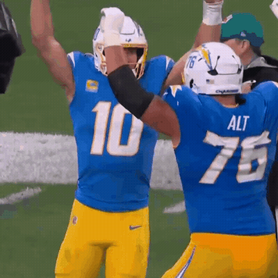 A Football Player Wearing A Blue Jersey With The Number 10 GIF
