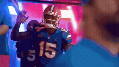 A Football Player Wearing A Blue Jersey With The Number 15 GIF