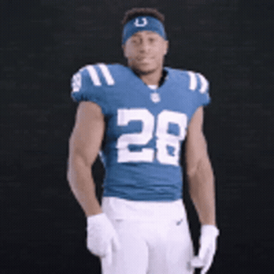 A Football Player Wearing A Blue Jersey With The Number 28 GIF
