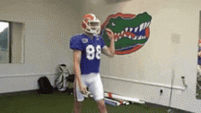 A Football Player Wearing A Blue Jersey With The Number 88 GIF