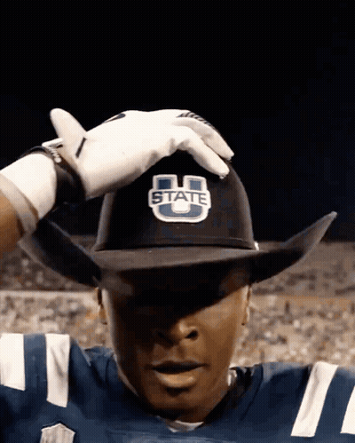 A Football Player Wearing A Cowboy Hat That Says State GIF
