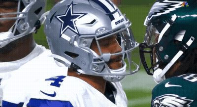 A Football Player Wearing A Cowboys Helmet Is Talking To Another Player GIF