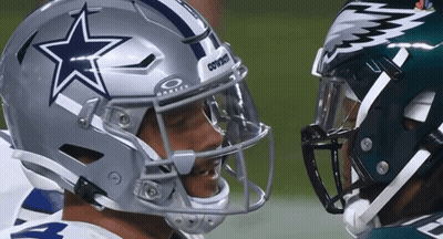 A Football Player Wearing A Cowboys Helmet Talks To Another Player GIF