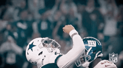 A Football Player Wearing A Cowboys Jersey And A New York Giants Helmet Celebrates A Touchdown . GIF