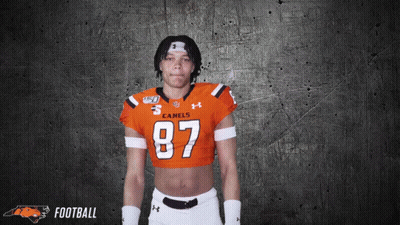 A Football Player Wearing A Crop Top With The Number 87 On It GIF