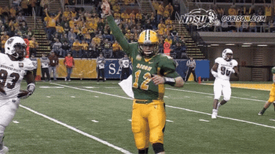 A Football Player Wearing A Green And Yellow Jersey With The Number 12 On It GIF