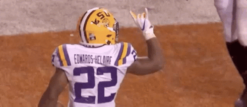A Football Player Wearing A Helmet And A Jersey With The Number 22 On It . GIF