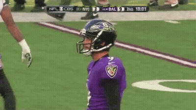 A Football Player Wearing A Helmet And A Ravens Jersey Is On The Field GIF