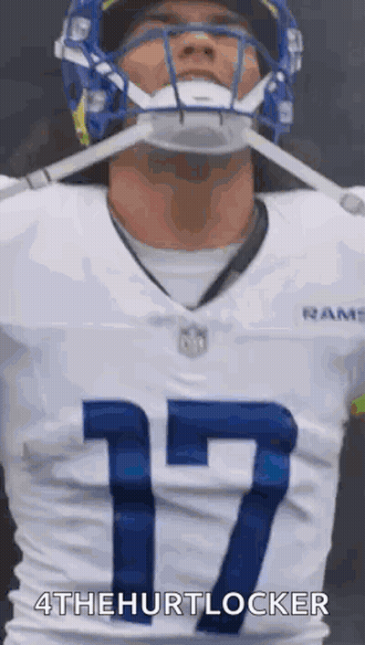 A Football Player Wearing A Helmet And A White Jersey With The Number 17 . GIF