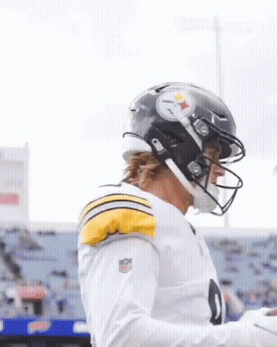 A Football Player Wearing A Helmet And A White Shirt With The Number 9 On It GIF