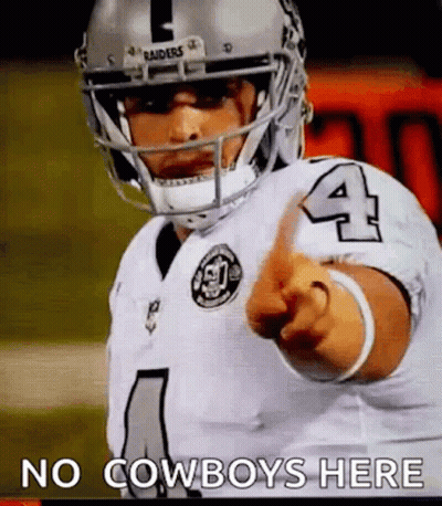 A Football Player Wearing A Helmet And Pointing At The Camera . GIF