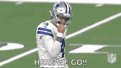 A Football Player Wearing A Helmet Is Standing On A Field . GIF