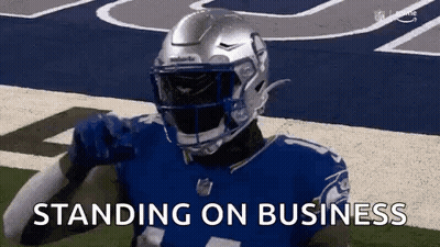 A Football Player Wearing A Helmet Is Standing On A Field With The Words `` Standing On Business '' . GIF