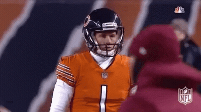 A Football Player Wearing A Helmet Is Talking To A Coach . GIF