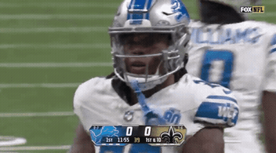 A Football Player Wearing A Helmet Stands On A Field With A Scoreboard Displaying The Score Of 0 To 39 GIF