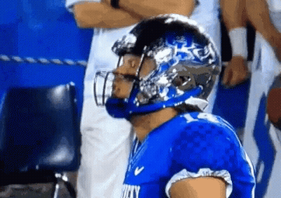 A Football Player Wearing A Helmet That Says Rocky GIF