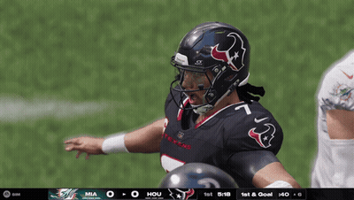 A Football Player Wearing A Helmet With A Bull On It Stands On The Field GIF