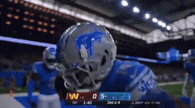 A Football Player Wearing A Helmet With A Lion On It Stands On The Field GIF