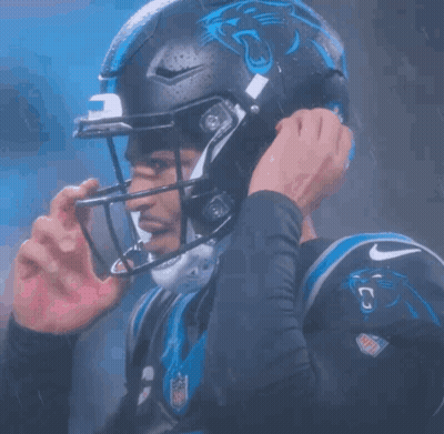 A Football Player Wearing A Helmet With A Panther On It GIF