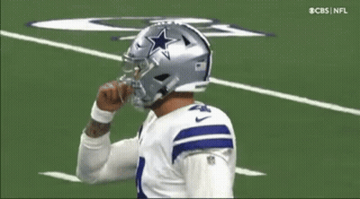 A Football Player Wearing A Helmet With A Star On It Is On The Field . GIF