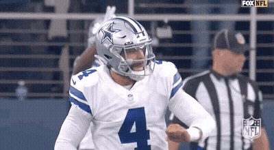 A Football Player Wearing A Helmet With A Star On It Is Running On The Field . GIF